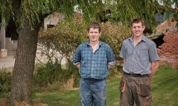 Howard and Tom Pattison standing under the willow tree in the garden of Willow Tree Farm